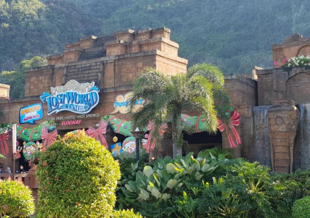 a disney theme park with a palm tree in front of a building at NO DEPOSIT - BIG Home 2-sty Terrace Near World Theme Park Hot Springs & Night Park max 6person in Ipoh