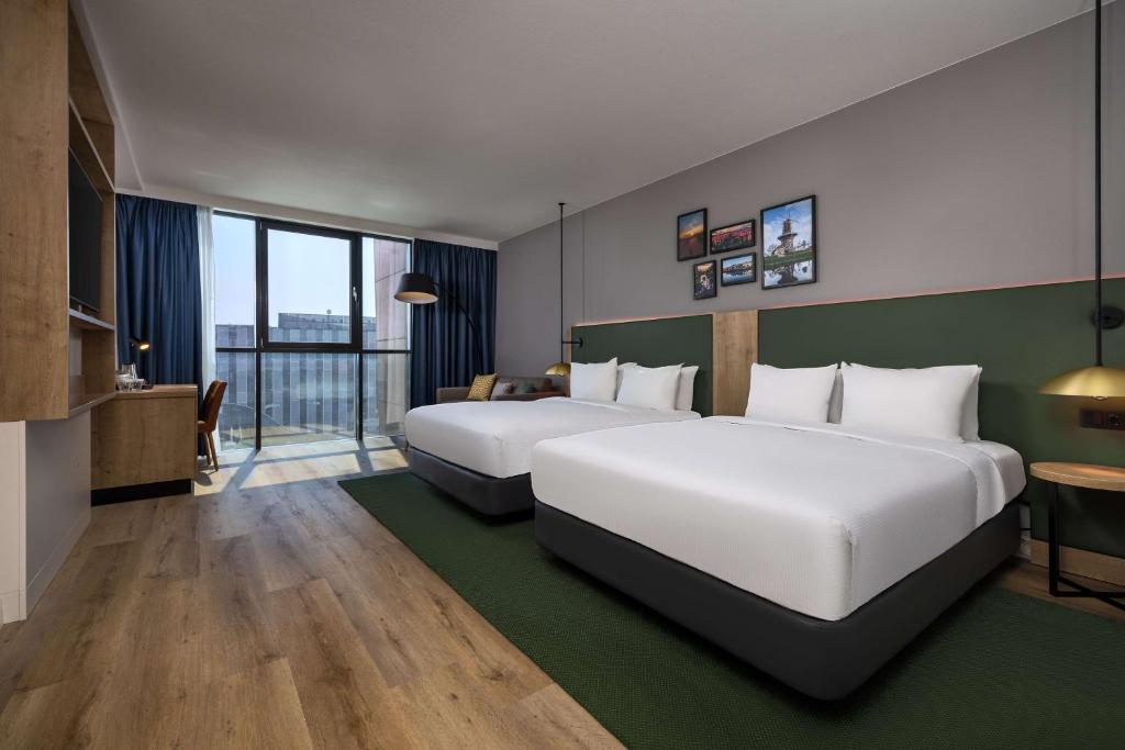 Postel nebo postele na pokoji v ubytování Hilton Garden Inn Leiden