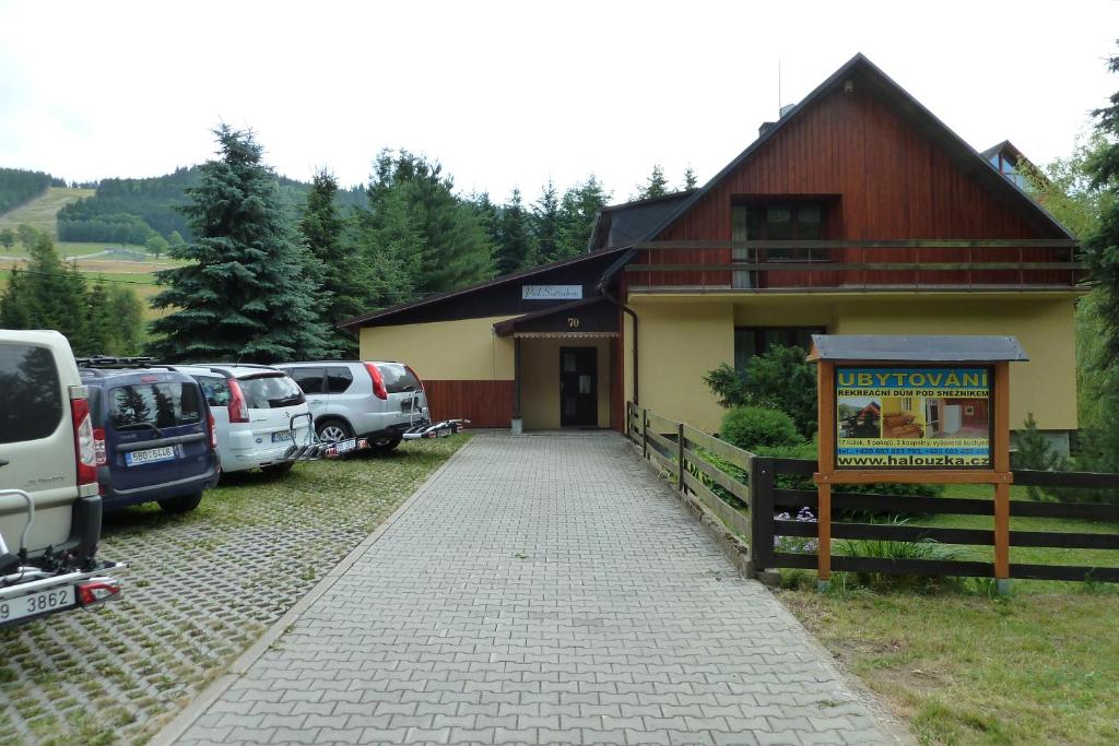 ein Gebäude mit Autos neben einem Parkplatz in der Unterkunft Pod Sněžníkem in Dolní Morava