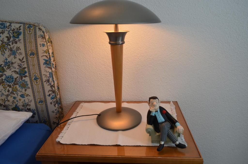 Una cama o camas en una habitación de Don Camillo Gästehaus