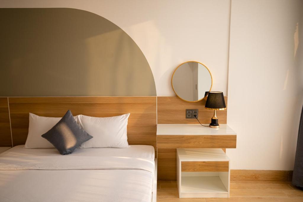 Rúm í herbergi á FIRST Studio Hotel Da Nang