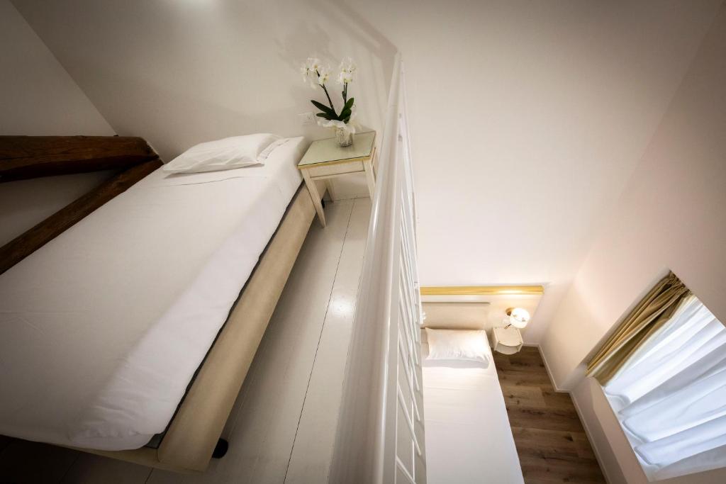 Postel nebo postele na pokoji v ubytování Hotel Ai Dogi