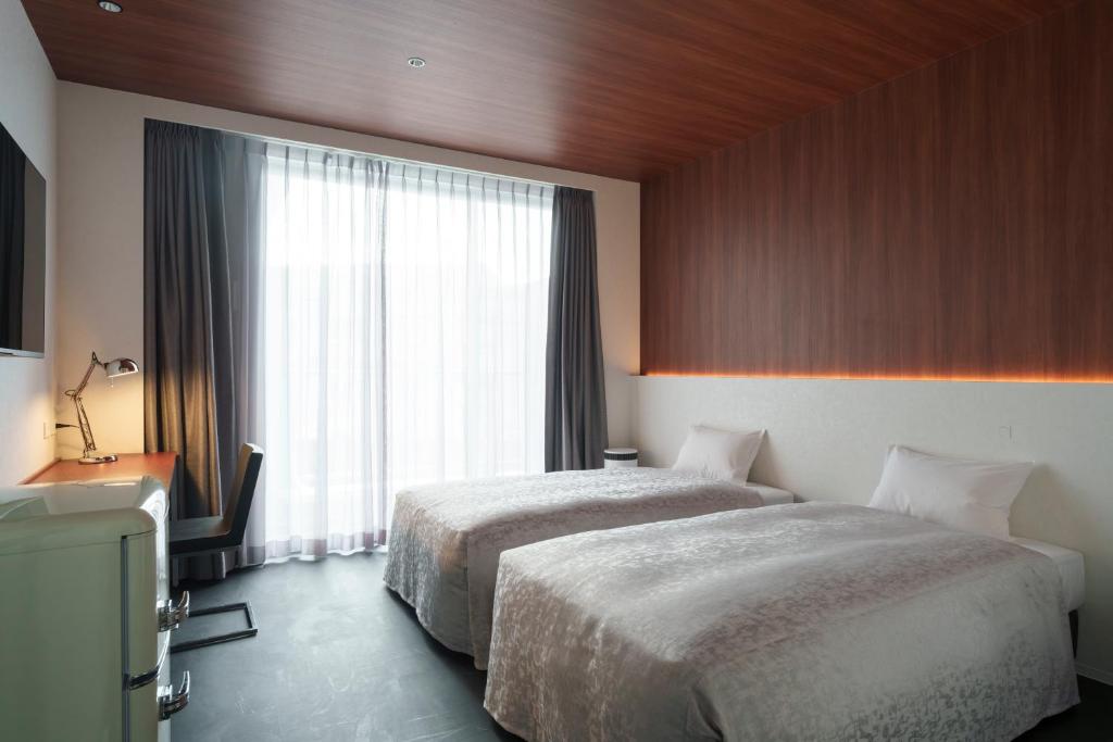 Bakery Hotel SHIRAHAMA ベーカリーホテル シラハマにあるベッド