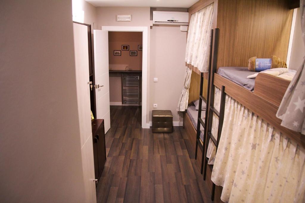 a hallway leading to a room with two bunk beds at Barcelona & You Hostel Sagrada Familia in Barcelona