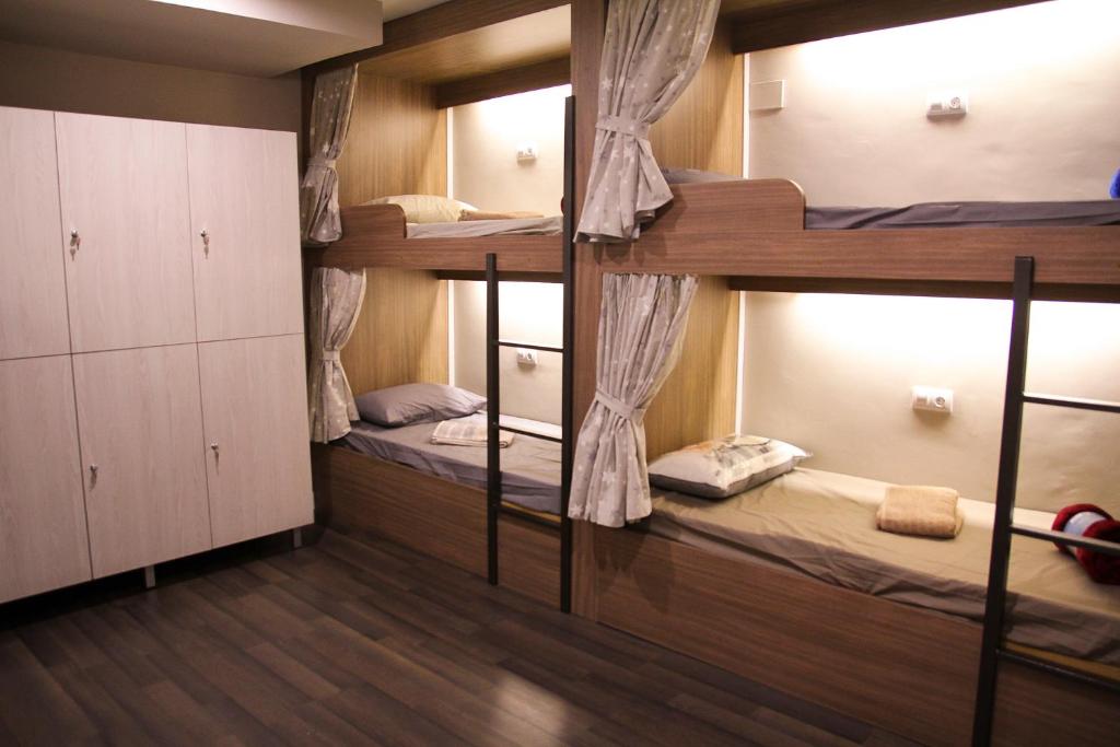 a room with three bunk beds in it at Barcelona & You Hostel Sagrada Familia in Barcelona