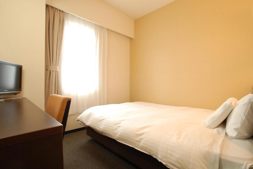 Postel nebo postele na pokoji v ubytování AB Hotel Okazaki