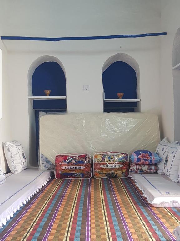 Postel nebo postele na pokoji v ubytování Tiwi Santorini