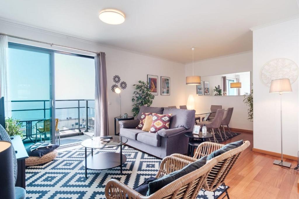 a living room with a couch and chairs at GuestReady - Sea breeze in Funchal in Funchal