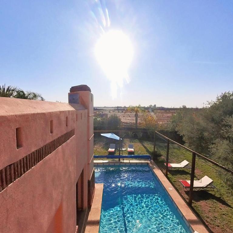 a swimming pool on the side of a building at Villa Belle vue - with a private & Heated pool in Marrakesh