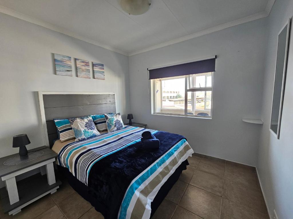 a bedroom with a bed and a window at Bly Nog Biki in Velddrif