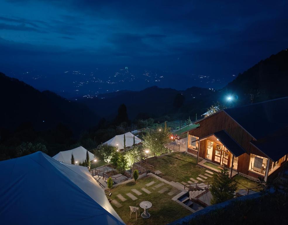 an aerial view of a house at night at The Bugyal in Kanatal