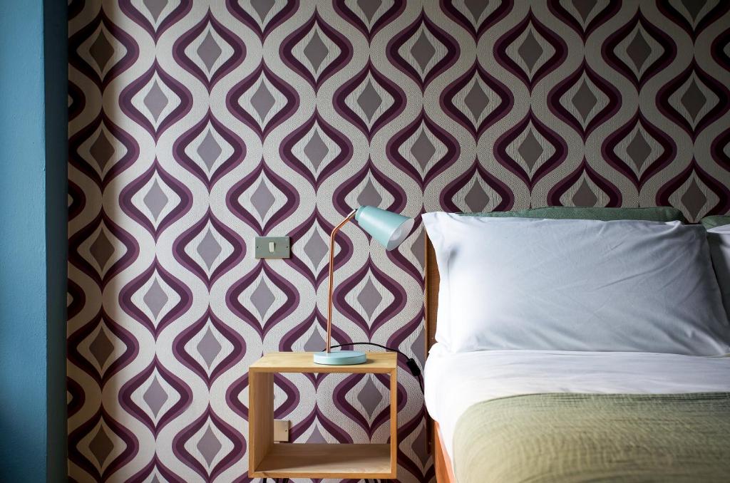A bed or beds in a room at Domus Plinii 1792 Suites