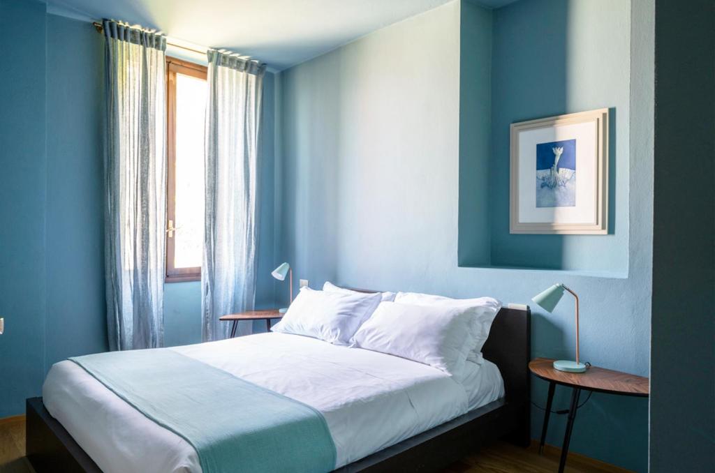 A bed or beds in a room at Domus Plinii 1792 Suites