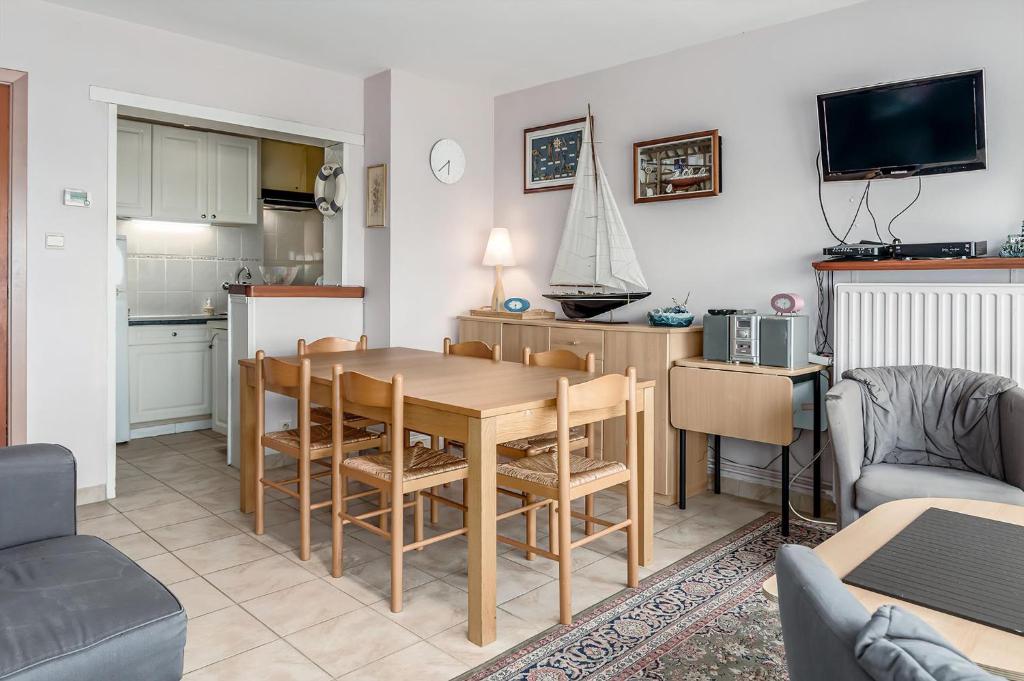 a kitchen and living room with a table and chairs at Europe 0402 in Sint-Idesbald