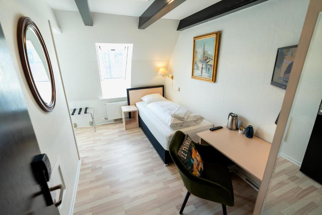 Ένα ή περισσότερα κρεβάτια σε δωμάτιο στο Prinsen Hotel