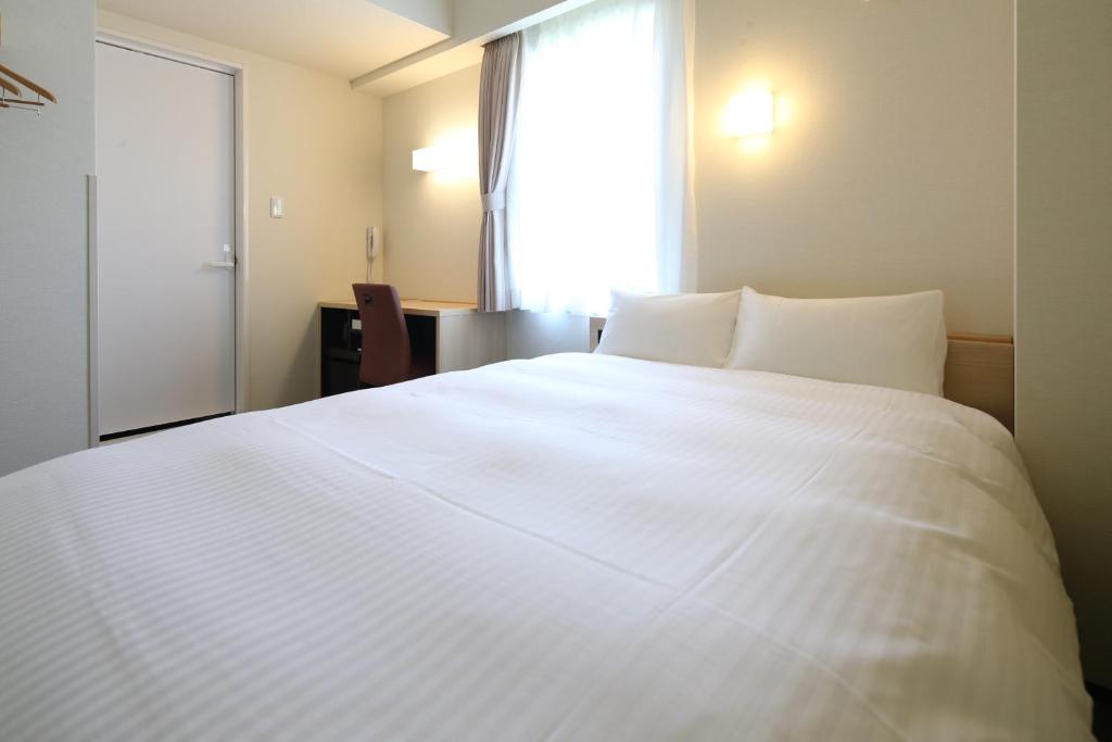 Postel nebo postele na pokoji v ubytování AB Hotel Seki