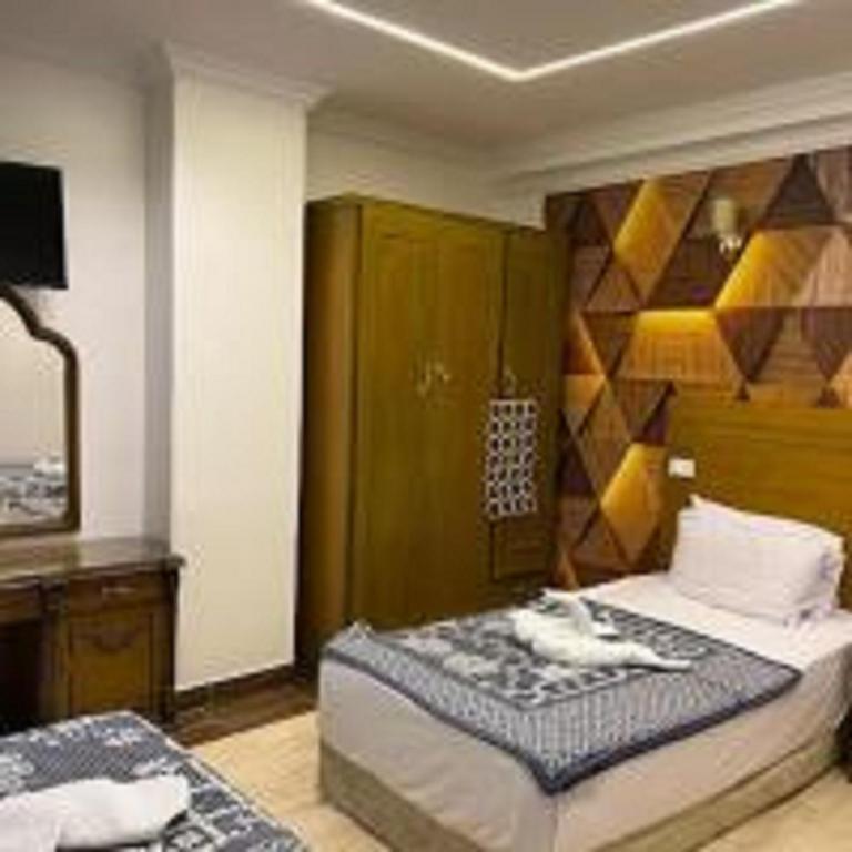 Postel nebo postele na pokoji v ubytování Pharoah's Palace hotel