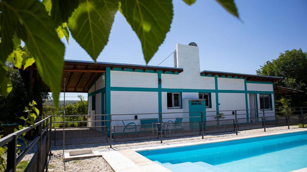 a house with a pool in front of it at Las Calandrias in Valle Hermoso