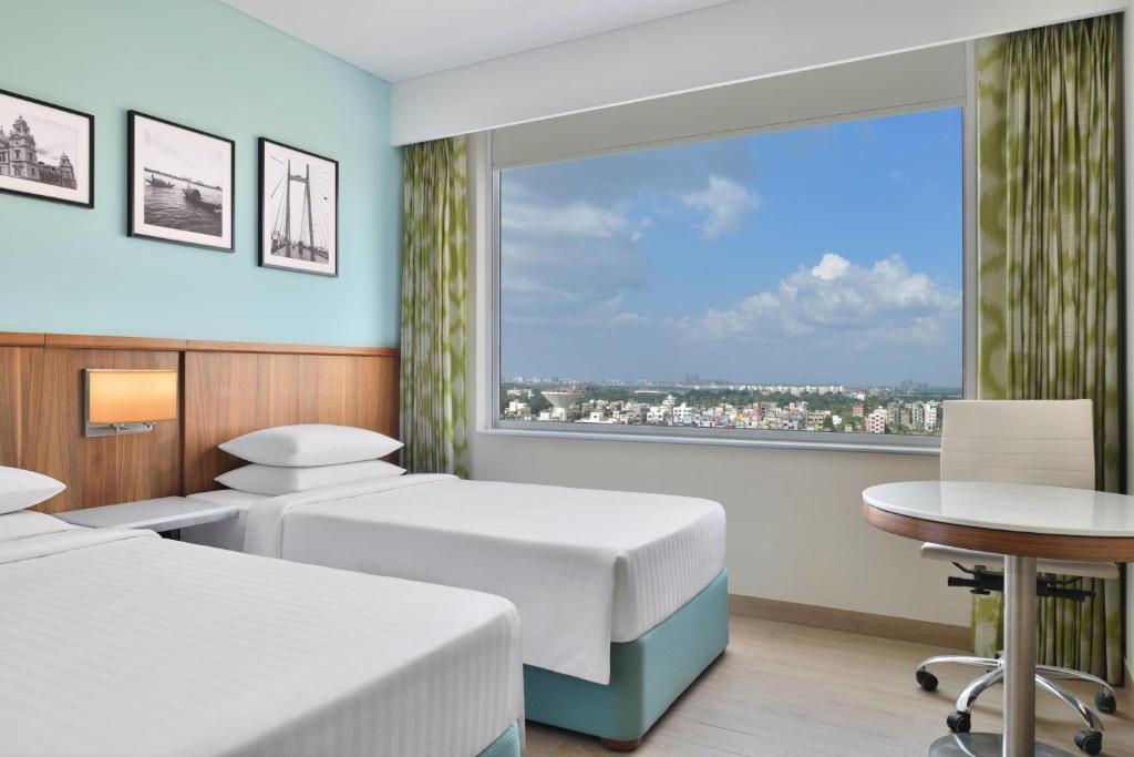 Postel nebo postele na pokoji v ubytování Fairfield by Marriott Kolkata