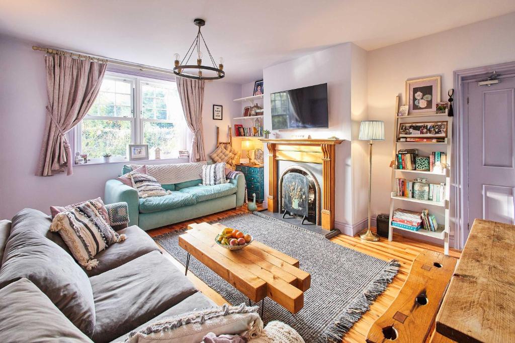 a living room with a couch and a fireplace at Host & Stay - Lilac Cottage in Morpeth