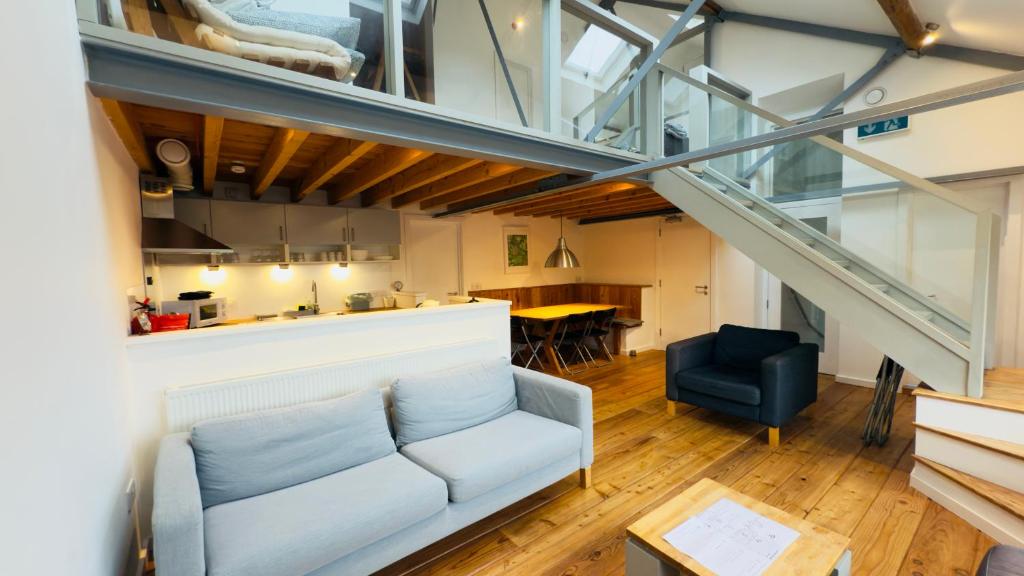 a living room with a couch and a table at Afan Forest BunkHouse - Gallery Apartment in Glyncorrwg