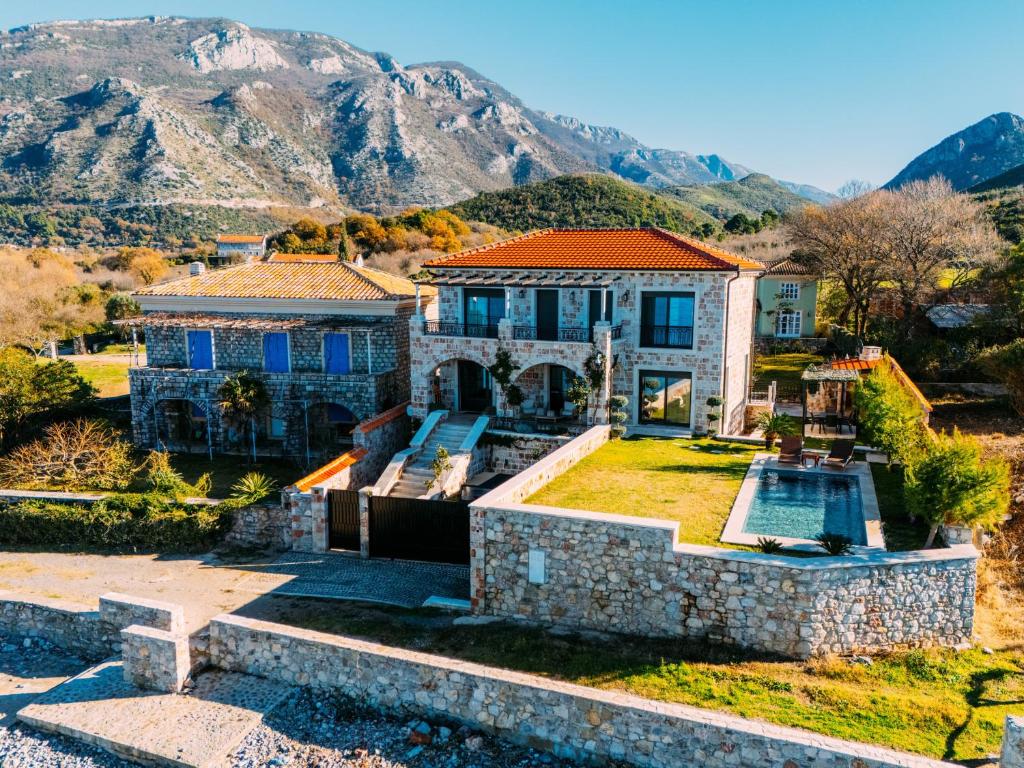 an aerial view of a house with mountains in the background at Villa Seaside Shore in Budva