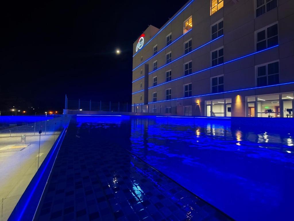 a large building with a swimming pool at night at Hotel y Casino del Río - Viedma in Viedma