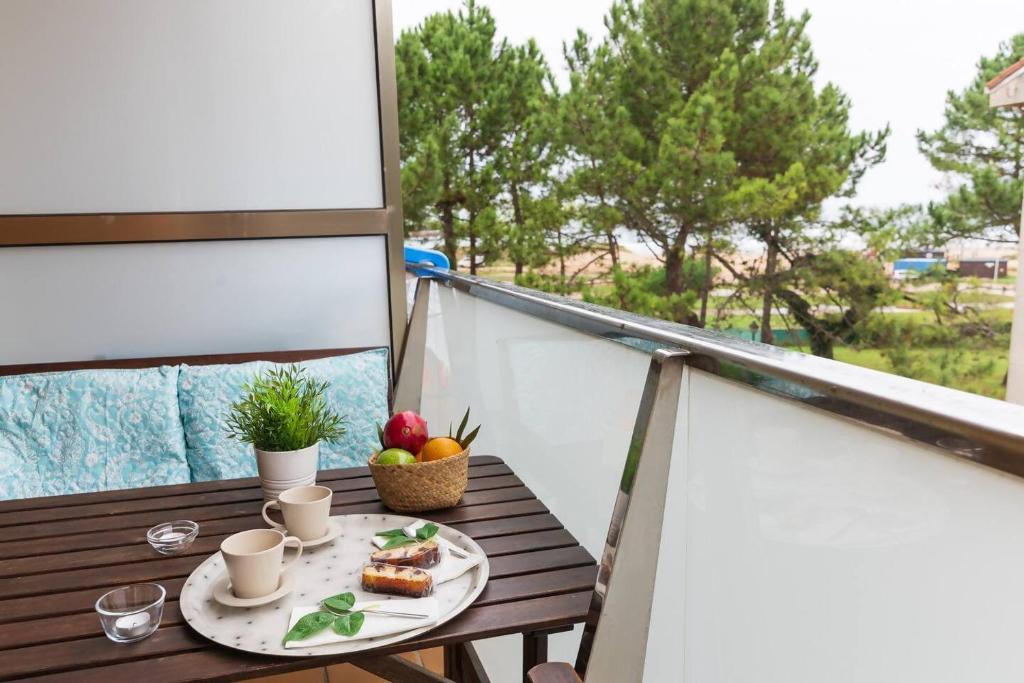 a table with a plate of food on a balcony at FGDR323H Las olas in San Vicente de la Barquera