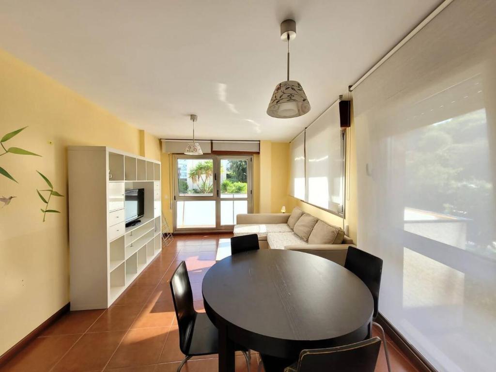 a living room with a table and a couch at FGDR34 1H "Cala Prellezo" in San Vicente de la Barquera