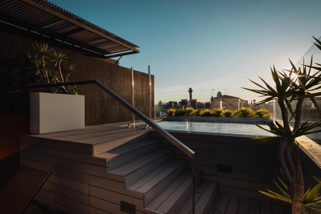 a view from the roof of a house with a swimming pool at Hotel Arconte, Adults Only in Barcelona