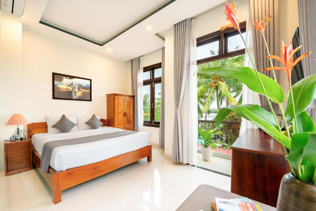 Postel nebo postele na pokoji v ubytování Sands River Hoi An Villa