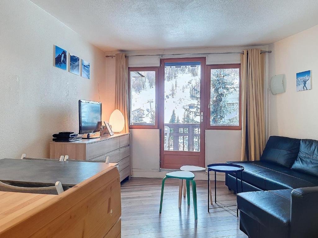 a living room with a couch and a table at Appartement skieurs, accès direct pistes, balcon sud, proche remontées - FR-1-518-109 in Val dʼIsère