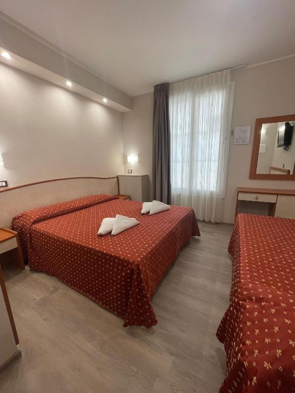 Postel nebo postele na pokoji v ubytování Hotel Harmony