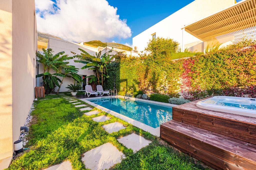 a backyard with a swimming pool and a house at Villa Jerina Green Coast by PikHost in Himare
