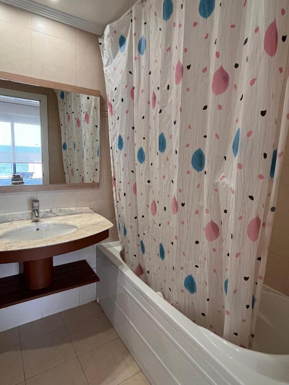 a bathroom with a shower curtain with polka dots at Apartamento en Altea con vistas al mar in Altea