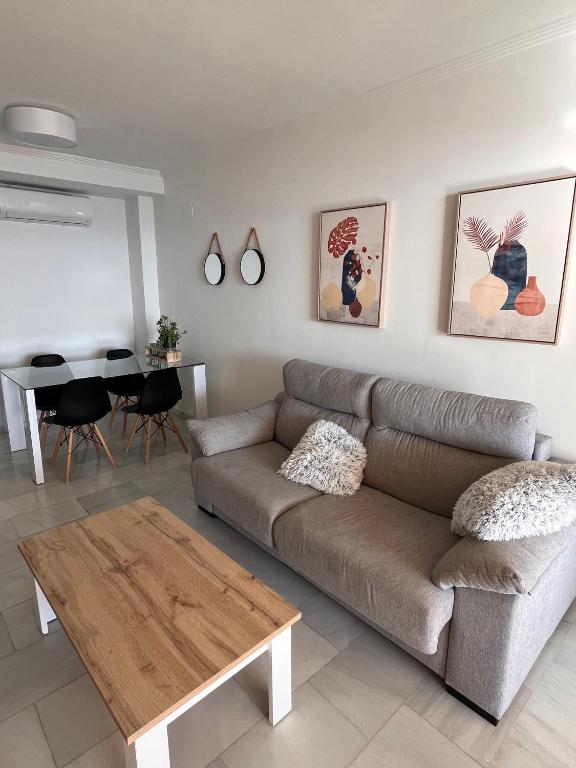 a living room with a couch and a table at Apartamento en Altea con vistas al mar in Altea