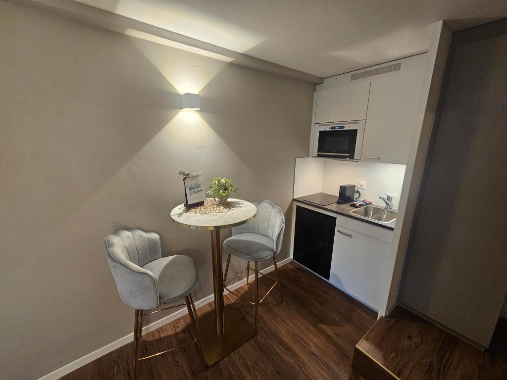 Kuchyň nebo kuchyňský kout v ubytování Apart-Hôtel Pont-de-Thielle