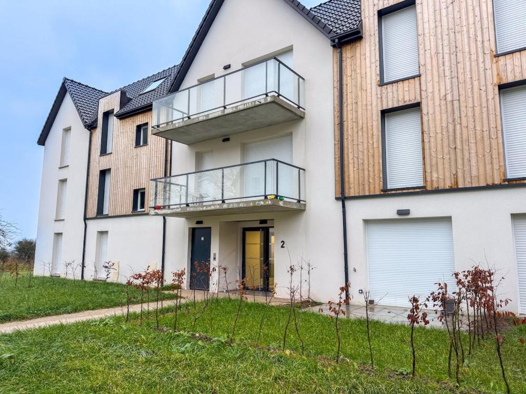Elle offre une vue sur l'extérieur d'une maison dotée d'un balcon. dans l'établissement Cocon de la Baie, terrasse et parking privé, à Saint-Valery-sur-Somme
