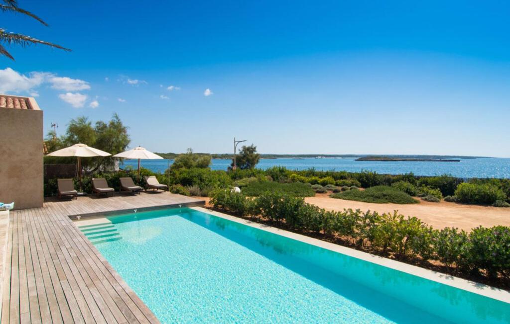 a swimming pool with a view of the ocean at Villa Cabrera in Colonia Sant Jordi