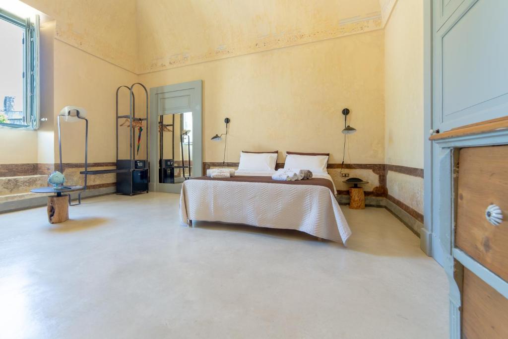 a bedroom with a bed in a room at Palazzo Angelica - Luxury Retreat Otranto in Giurdignano