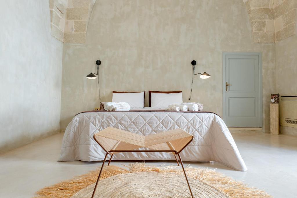 a bedroom with a bed with a book on it at Palazzo Angelica - Luxury Retreat Otranto in Giurdignano