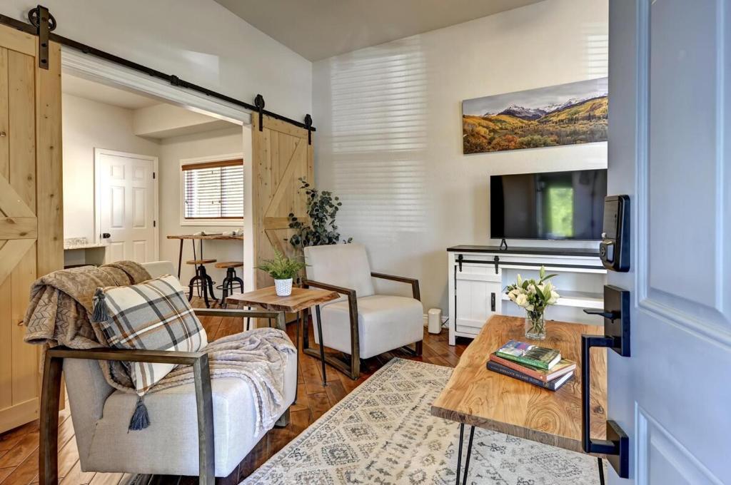 a living room with a couch and a table at Historic Downtown Trails & Park in Colorado Springs