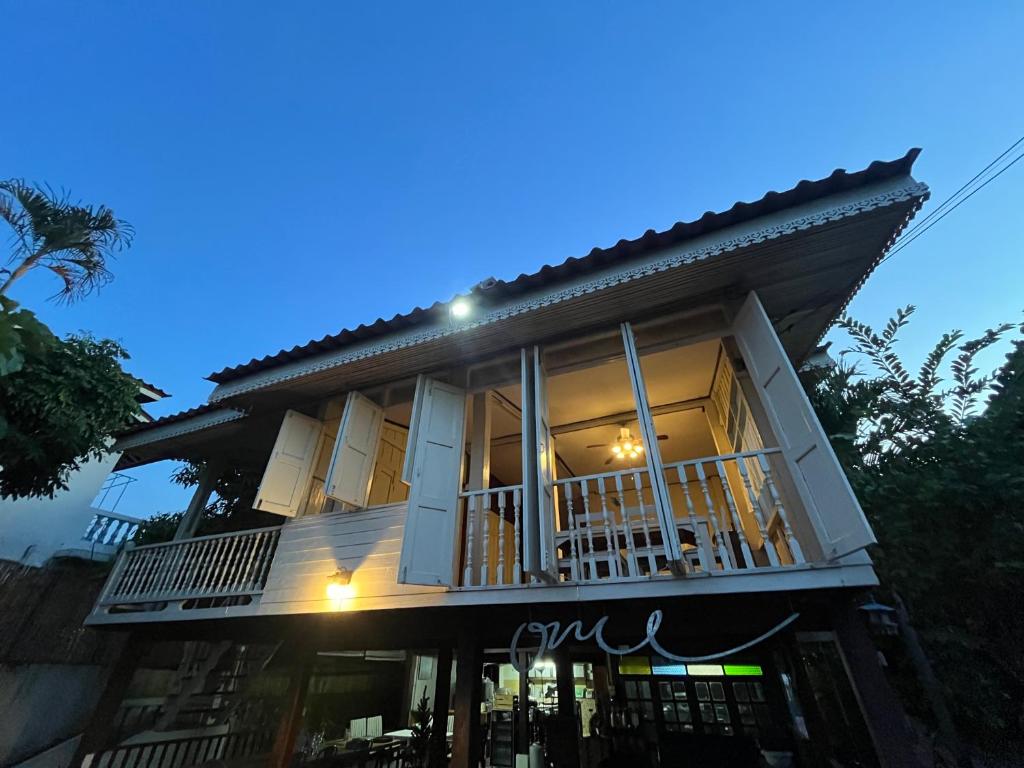 a house with a balcony in front of it at Once in Lampang Guesthouse in Lampang