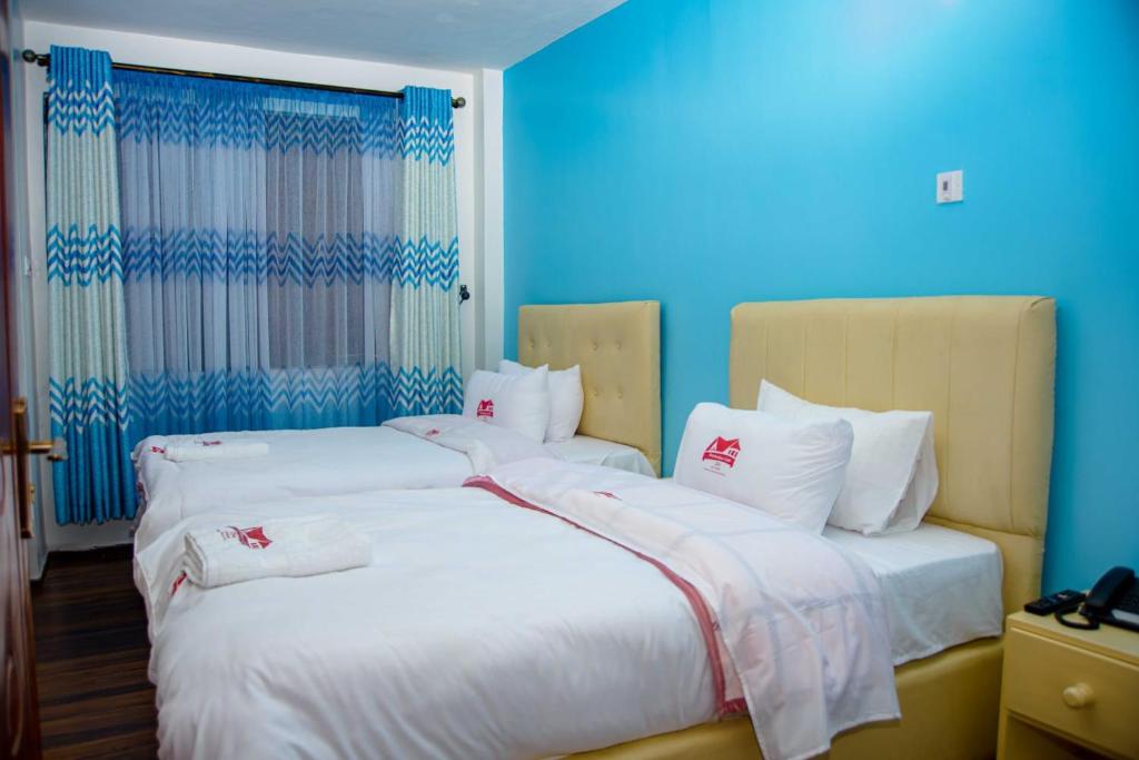 Rúm í herbergi á Destination code 254, Nyeri