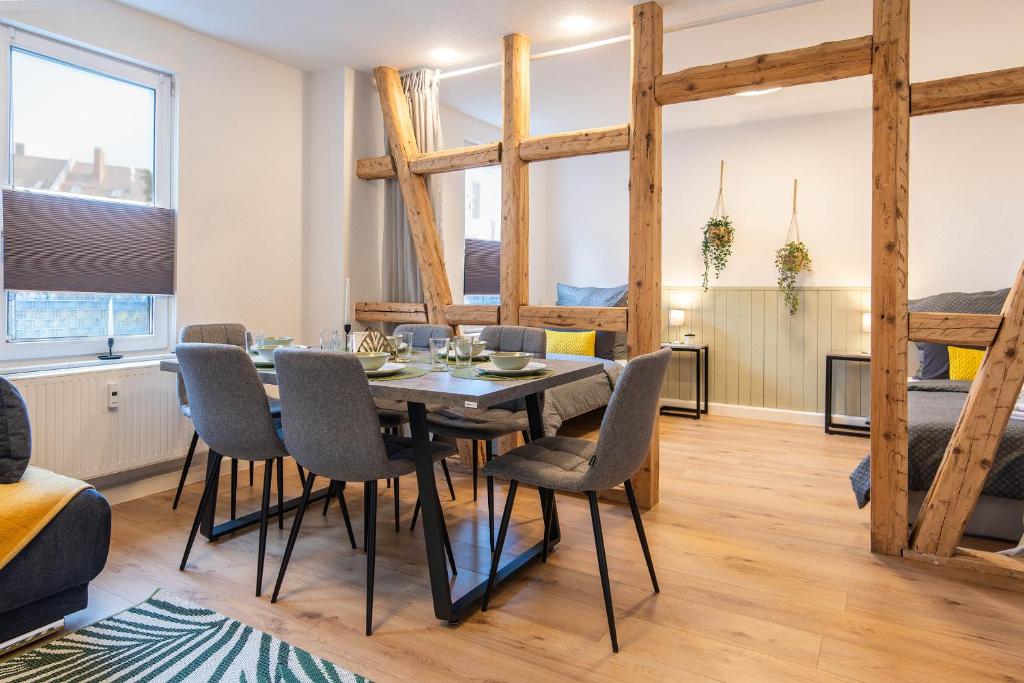a dining room and living room with a table and chairs at Apartment - Terrasse - Modern - Küche in Gotha