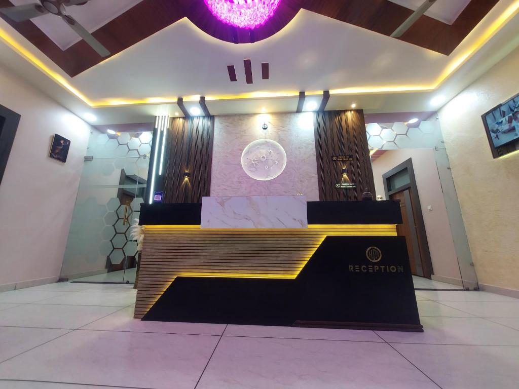 a stage in a room with a sign on it at Hotel Moon in Mahoba