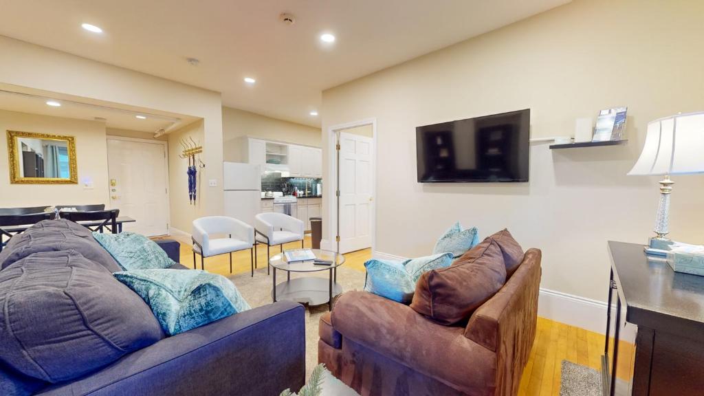 a living room with two couches and a tv at Newly Renovated 2-bed, Back Bay Near Mgh, Bu, Mit in Boston