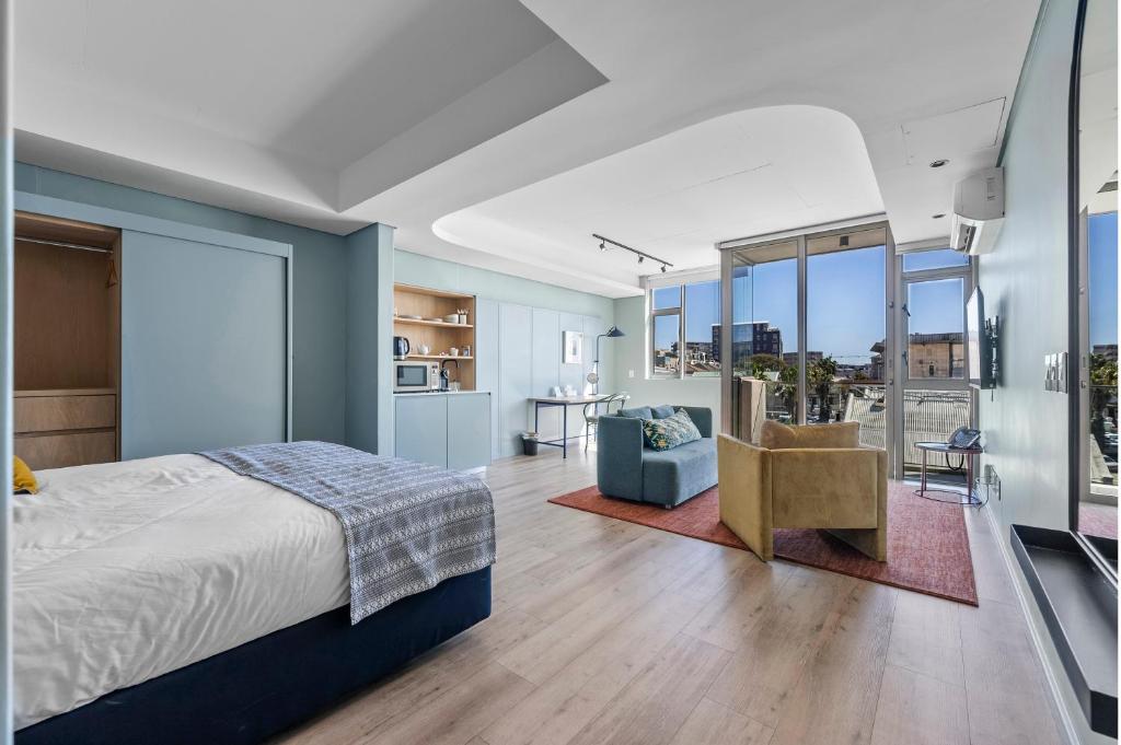 a bedroom with a bed and a blue wall at Quarter 411 in Cape Town