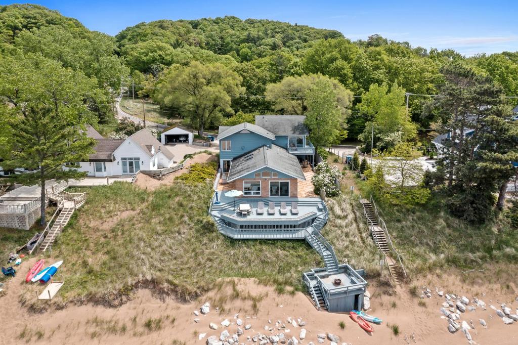 an aerial view of a house with a boat on a beach at Beachside Getaway private Lake Michigan Beach Frontage in Spring Lake