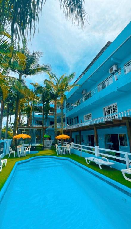 a large swimming pool in front of a building at Pousada Bella Praia in Torres